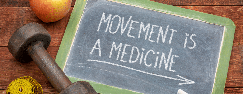 chalkboard sign with the words movement is a medicine